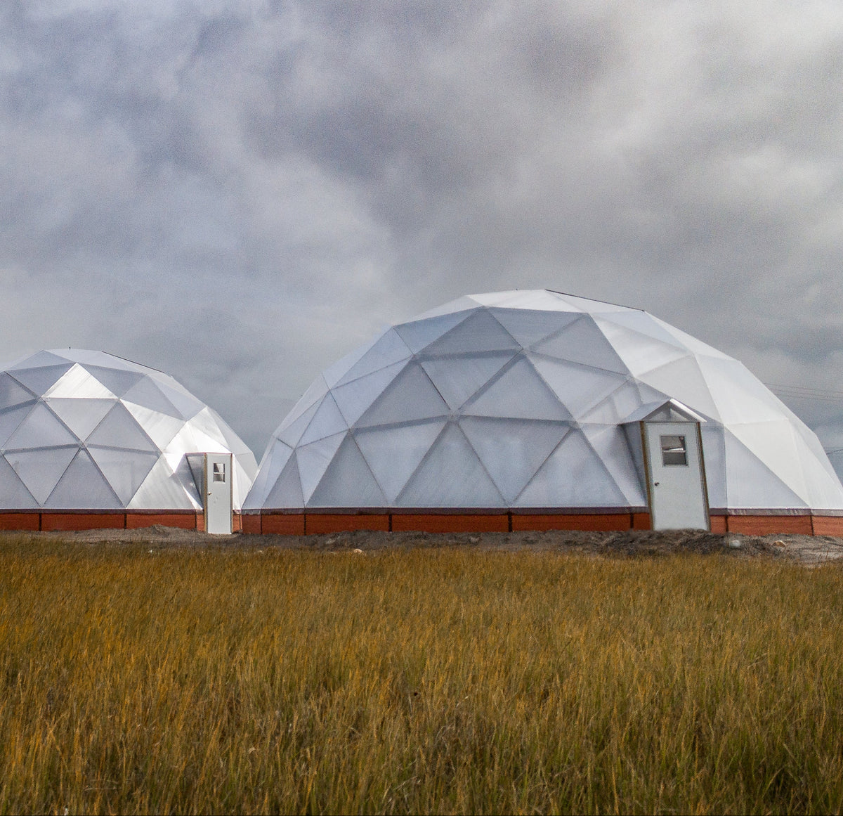 Geodesic growing dome greenhouse on a farm property